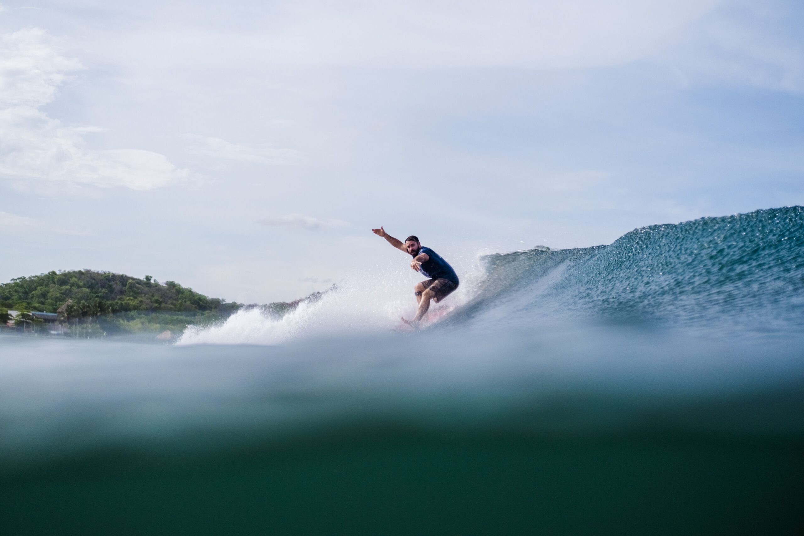 Man over 40 surfing a wave in Nicaragua