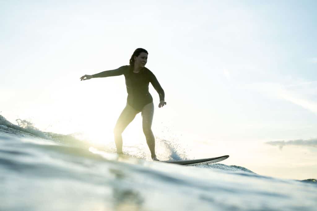 surfer on the wave after a retreat community service day