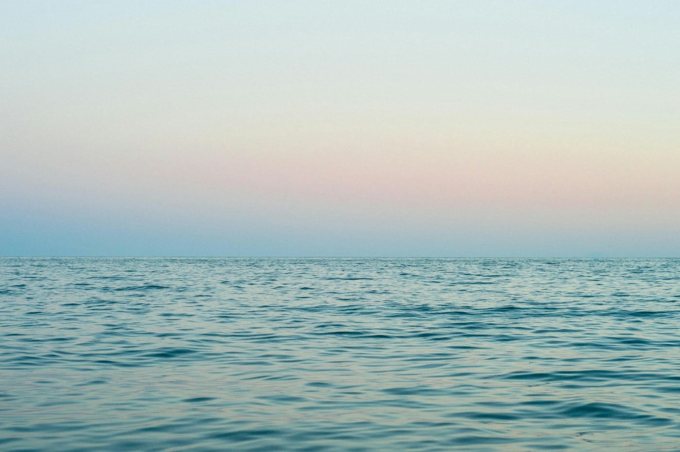 still waters of the ocean at sunrise