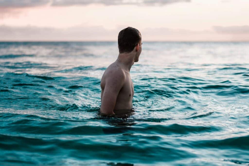 man immersed in ocean water